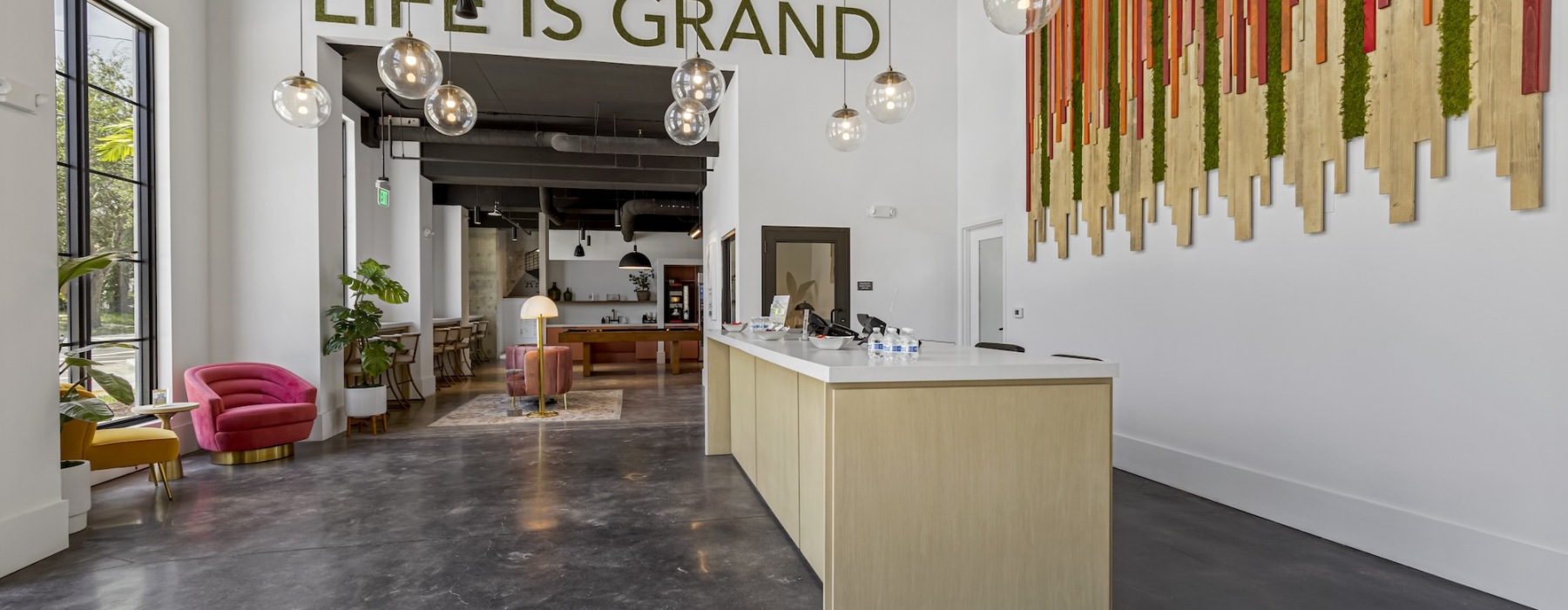 lobby with a front desk and hanging lights